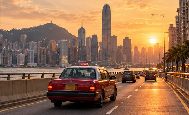 Hong Kong taxi and skyline at sunset
